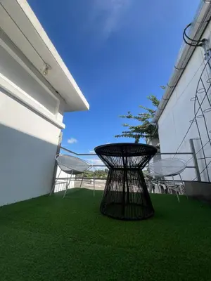 a black table and chairs on the side of a building at VILLA NAPOLI in Santa Ana