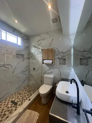 a bathroom with a toilet and a shower and a sink at VILLA NAPOLI in Santa Ana