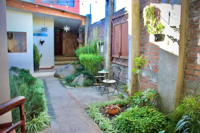 a courtyard with a table and chairs in a building at Villa Stahl in San Salvador