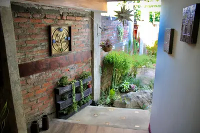 a brick wall with a window and plants on it at Villa Stahl in San Salvador