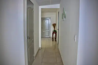 a hallway with a door and a vase on a table at Villa Stahl in San Salvador