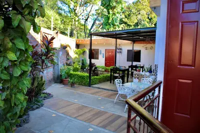 a patio with a table and chairs on a deck at Villa Stahl in San Salvador