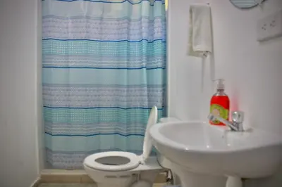 a bathroom with a white toilet and a sink at Villa Stahl in San Salvador