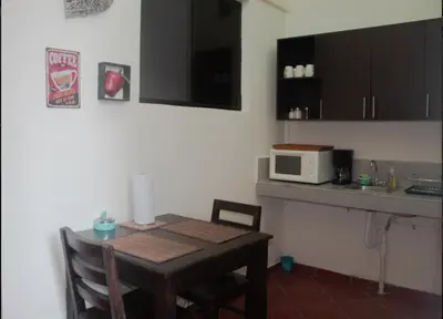 a small kitchen with a table and a microwave at Villa Stahl in San Salvador