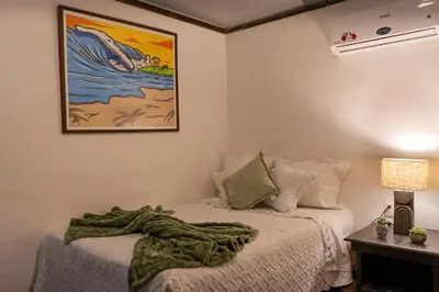 a bedroom with two beds with a blanket on them at Hotel Martinez in Conchagüita