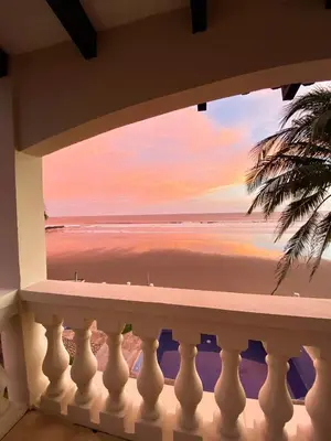 a view of the beach from a balcony at Vista Las Olas Resort in El Cuco