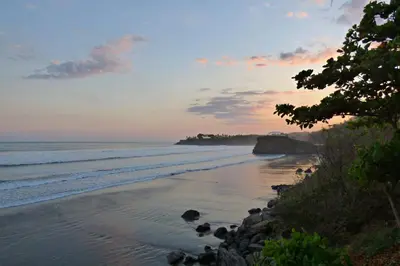 a view of the beach at sunset at Vista Las Olas Resort in El Cuco