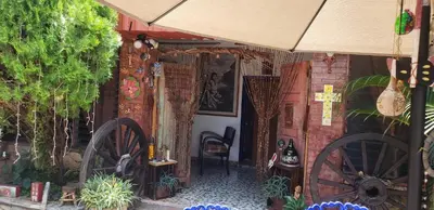 an entrance to a building with large wooden wheels at Mendoza’s Guest House in Santa Ana