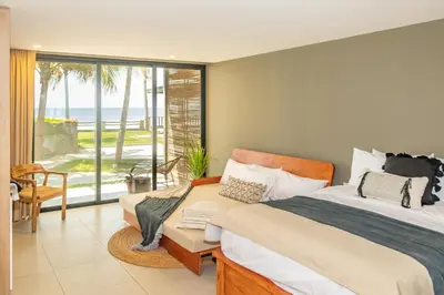 a bedroom with a bed and a view of the ocean at Fishermans Resort Life in La Libertad