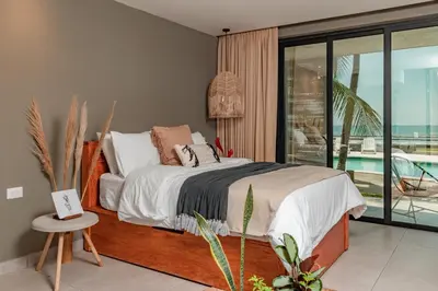 a bedroom with a bed and a view of the ocean at Fishermans Resort Life in La Libertad