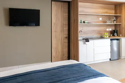 a bedroom with a bed and a tv on a wall at Fishermans Resort Life in La Libertad