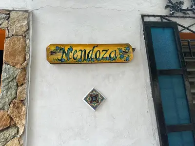 a sign on the side of a building at Mendoza’s GUESTHOUSE in Santa Ana