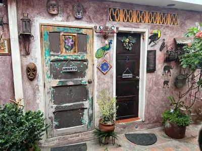 an old building with a door and two plants at Mendoza’s GUESTHOUSE in Santa Ana