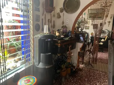 a living room with a heater and a window at Mendoza’s GUESTHOUSE in Santa Ana