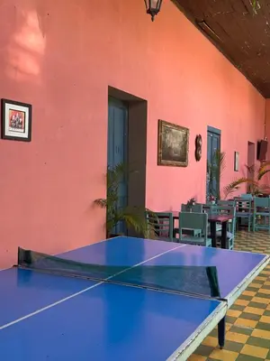 a ping pong table in front of a pink wall at Hotel Brunette in Santa Ana
