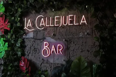 a neon sign that says a alejandro bar at Hotel Brunette in Santa Ana