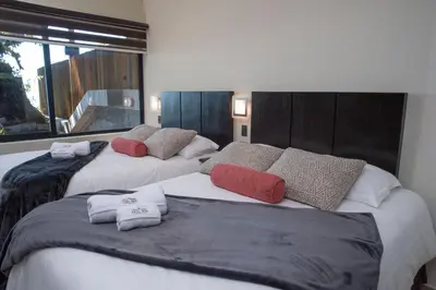 two beds with pillows on them in a room at Casa 1800 Cerro Verde in Cerro Verde
