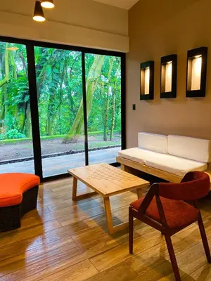 a living room with a bench and a table and a window at Casa 1800 Cerro Verde in Cerro Verde