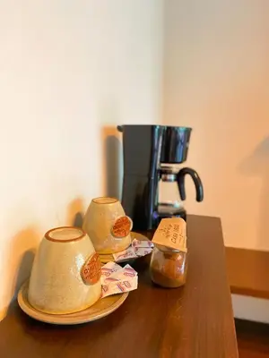 a table with two plates of food and a coffee maker at Casa 1800 Cerro Verde in Cerro Verde