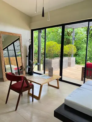 a bedroom with a bed and a table and a chair at Casa 1800 Cerro Verde in Cerro Verde