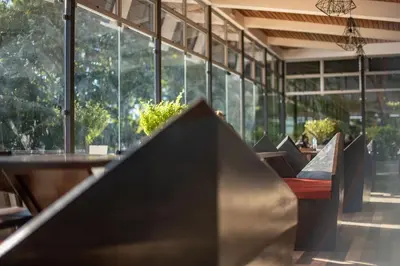 a row of chairs in a restaurant with windows at Casa 1800 Cerro Verde in Cerro Verde