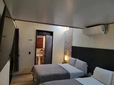 a hotel room with two beds and a bathroom at Green life in San Salvador