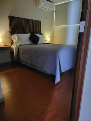 a bedroom with a bed and a wooden floor at Green life in San Salvador