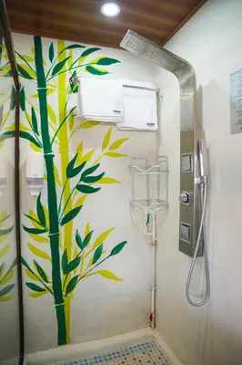 a bathroom with a mural of a tree on the wall at Boutike Art & Wellness in Concepción de Ataco