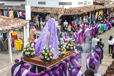 a group of women in purple robes walking down a street at Boutike Art & Wellness in Concepción de Ataco
