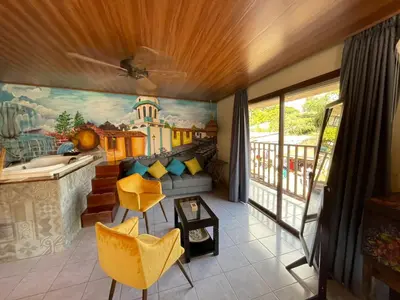a living room with a painting on the wall at Boutike Art & Wellness in Concepción de Ataco