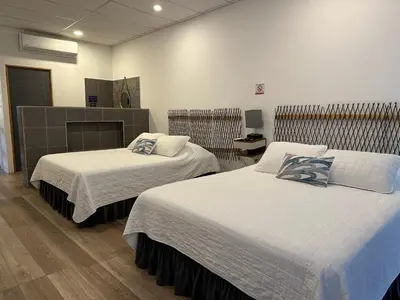 a room with two beds in a room at Lali Beach Hotel Boutique in Sonsonate