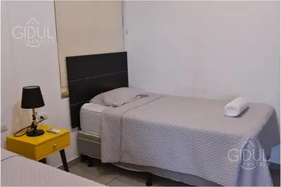 a bedroom with two beds and a lamp on a table at Volcano Views Apartment in San Salvador