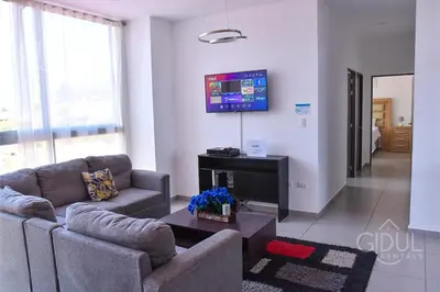 a living room with two couches and a tv at Volcano Views Apartment in San Salvador