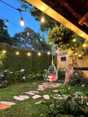 a swing in a garden with a tree at Casa Heidi, Apaneca in Apaneca