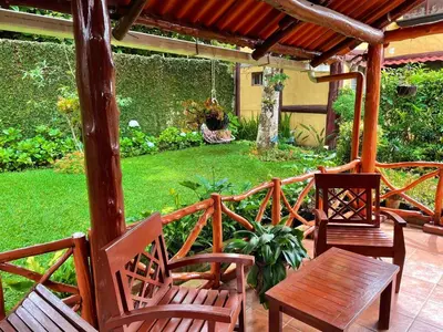 a patio with two chairs and a table and a swing at Casa Heidi, Apaneca in Apaneca