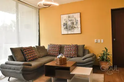 a living room with a couch and a table at Infinity Pool Apartment in San Salvador