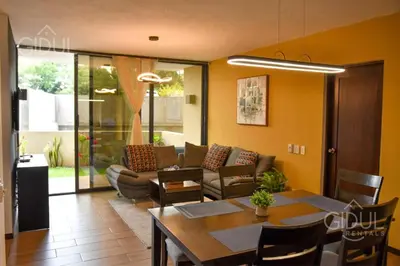 a living room with a table and a couch at Infinity Pool Apartment in San Salvador