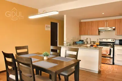 a kitchen and dining room with a table and chairs at Infinity Pool Apartment in San Salvador