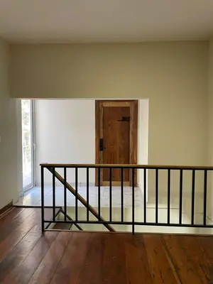 an empty room with a staircase and a wooden door at Hotel Finca San Nicolas in San Salvador