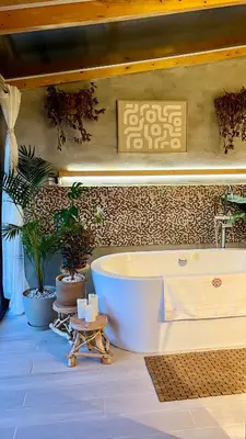 a bath tub in a bathroom with plants at Los Naranjos Town Houses in Los Naranjos