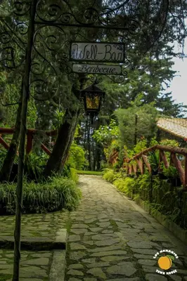 a stone path with a sign on the side of a building at Los Naranjos Town Houses in Los Naranjos
