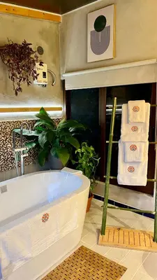 a bathroom with a bath tub and towels at Los Naranjos Town Houses in Los Naranjos