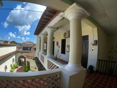 a balcony of a house with columns at Ricks hostel Santa Ana in Santa Ana