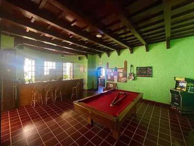 a room with a pool table and a bar at Ricks hostel Santa Ana in Santa Ana