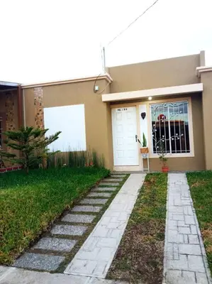a house with a walkway in front of it at La Casa Del Pinito in Sonsonate