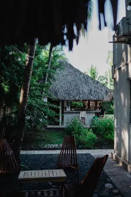 a resort with two chairs and a thatch roof at Casaola Mizata in Santa María Mizata