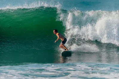 a man riding a wave on a surfboard in the ocean at Casaola Mizata in Santa María Mizata