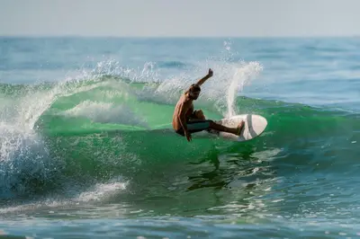 a man riding a wave on a surfboard in the ocean at Casaola Mizata in Santa María Mizata