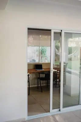 a room with sliding glass doors with a desk at Casaola Mizata in Santa María Mizata