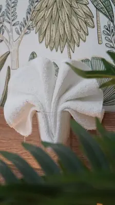 a white towel sitting on top of a table at Kali Hotel in Santa Ana